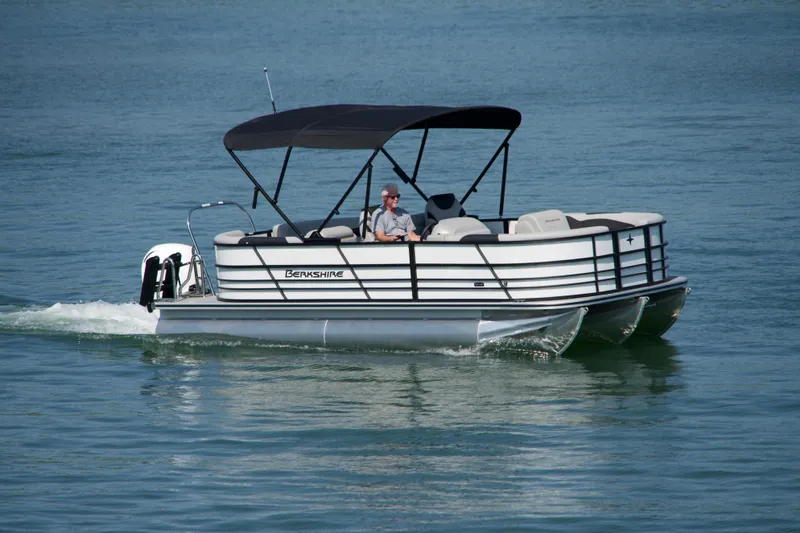 Slide: The Image of 2026 Berkshire 22 RFX LE pontoon boat cruising on a calm lake. - 18