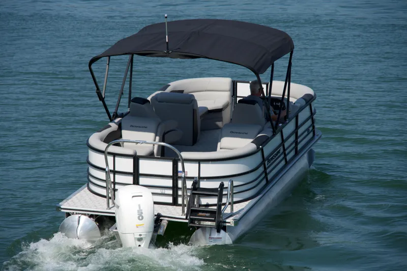 Slide: The Image of 2026 Berkshire 22 RFX LE pontoon boat cruising on a calm lake. - 21