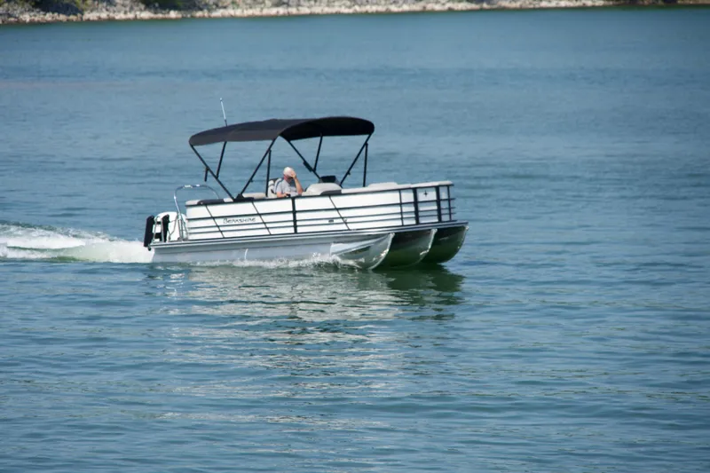 Slide: The Image of 2026 Berkshire 22 RFX LE pontoon boat cruising on a calm lake. - 23