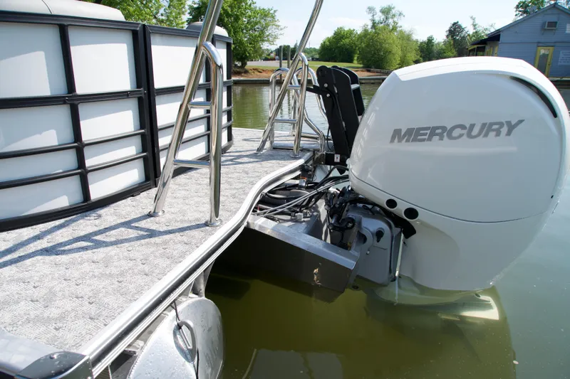 Slide: The Image of 2026 Berkshire 22 RFX LE pontoon boat with Mercury outboard engine on a calm lake. - 3
