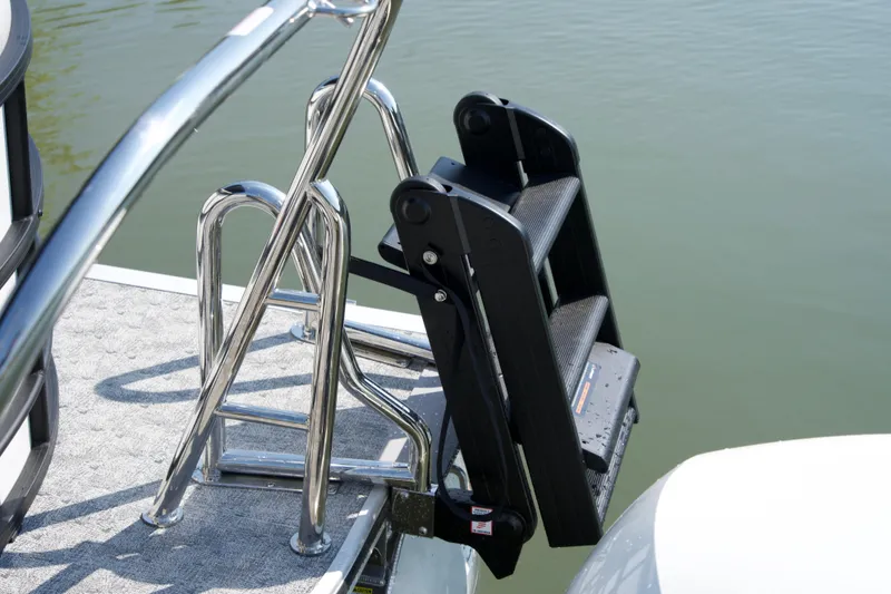 Slide: The Image of Stainless steel ladder on 2026 Berkshire 22 RFX LE pontoon boat by the water. - 4