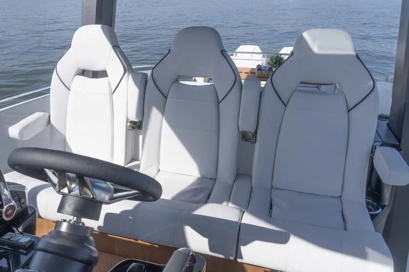 Slide: The Image of 2026 Beneteau Gran Turismo 35 cockpit with white leather seats and steering wheel. - 16