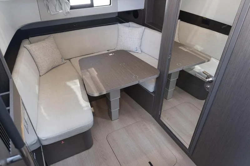 Slide: The Image of Interior of 2026 Beneteau Gran Turismo 35 yacht with cozy seating and table. - 18