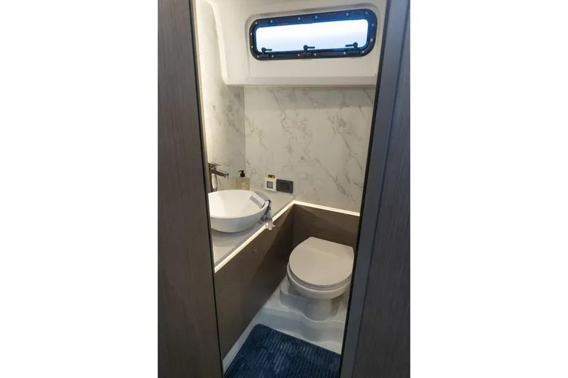Slide: The Image of Bathroom interior of 2026 Beneteau Gran Turismo 35 yacht, featuring modern fixtures and marble accents. - 19