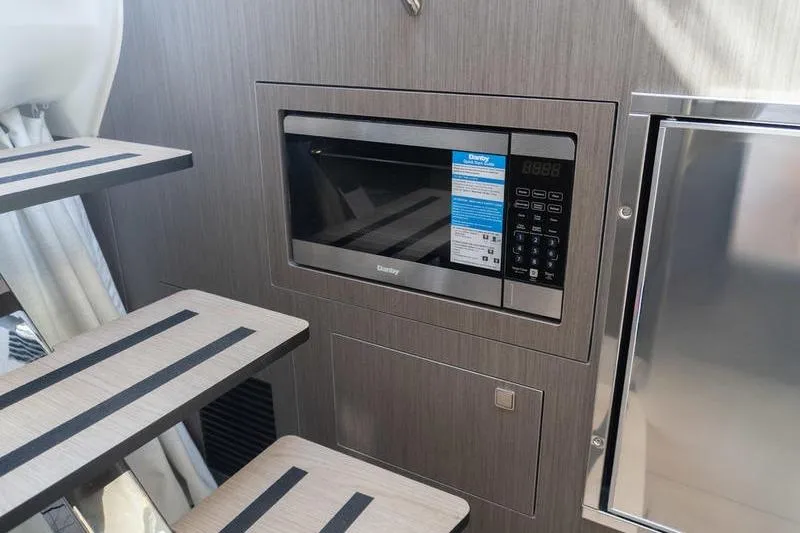Slide: The Image of Modern kitchen area in 2026 Beneteau Gran Turismo 35 yacht with microwave. - 22