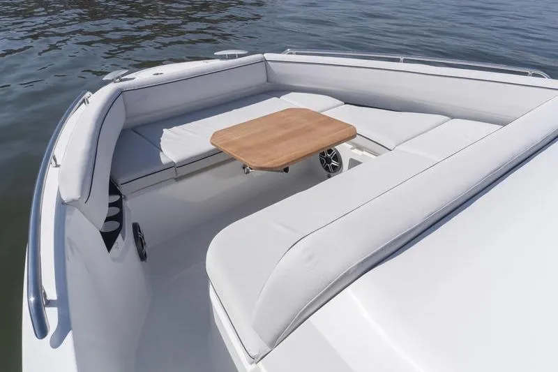 Slide: The Image of Luxury seating area on 2026 Beneteau Gran Turismo 35 yacht with wooden table. - 25