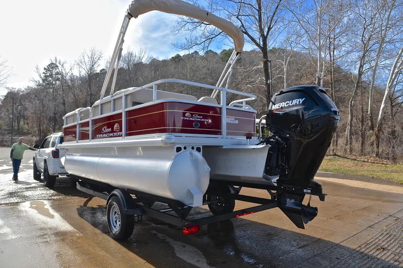 Slide: The Image of 2023 Sun Tracker Party Barge 18 DLX pontoon boat on trailer, with Mercury outboard motor. - 12