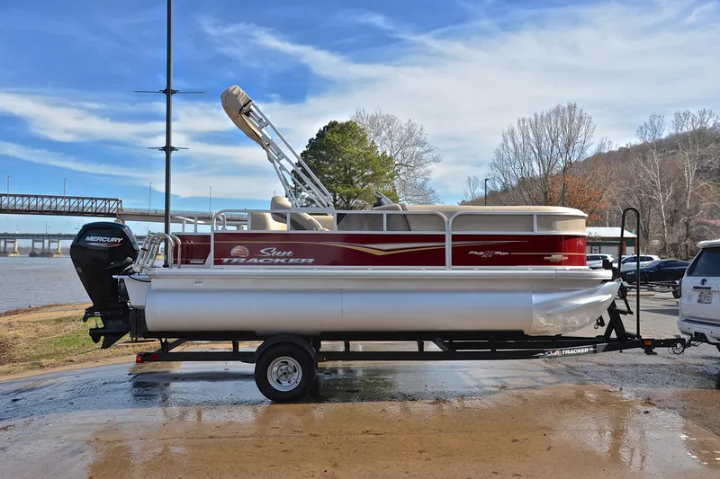 Slide: The Image of 2023 Sun Tracker Party Barge 18 DLX pontoon boat on trailer by riverside. - 15