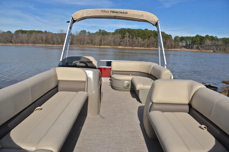 Slide: The Image of 2023 Sun Tracker Party Barge 18 DLX pontoon boat on a serene lake. - 20
