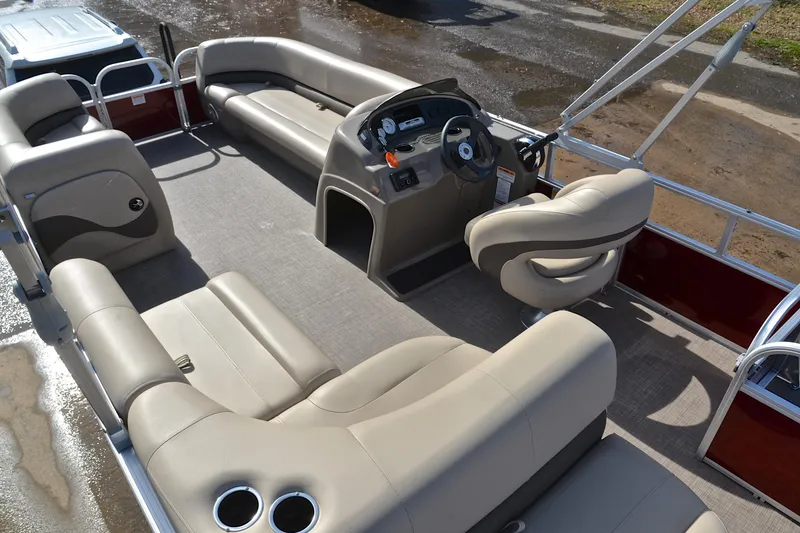 Slide: The Image of 2023 Sun Tracker Party Barge 18 DLX interior with spacious seating and steering console. - 22