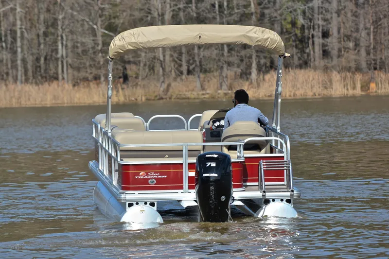 Slide: The Image of 2023 Sun Tracker Party Barge 18 DLX pontoon boat on a calm lake. - 7