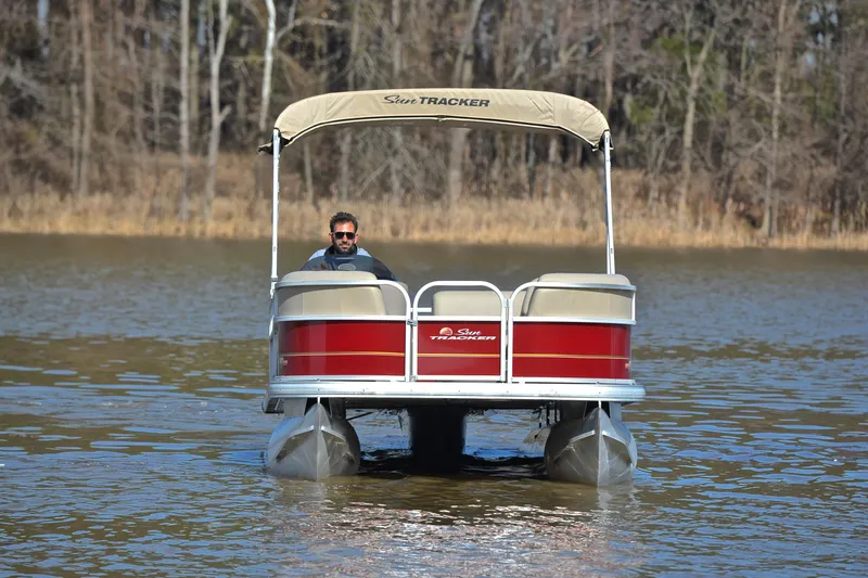 Slide: The Image of 2023 Sun Tracker Party Barge 18 DLX pontoon boat on a calm lake. - 8
