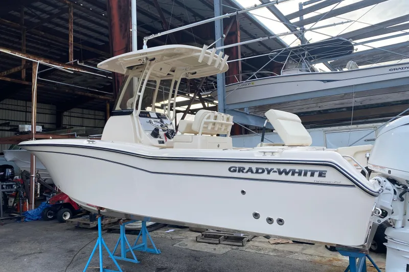 Slide: The Image of 2024 Grady-White Fisherman 257 boat in a storage facility, side view. - 2