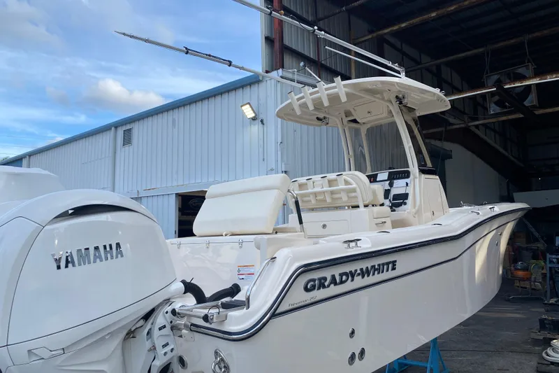 Slide: The Image of 2024 Grady-White Fisherman 257 boat with Yamaha engine in a marina setting. - 3