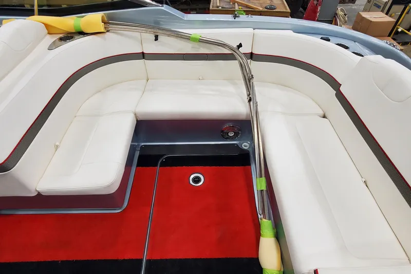 Slide: The Image of 2011 Formula 310 FX5 Bowrider interior with white seating and storage compartment. - 10