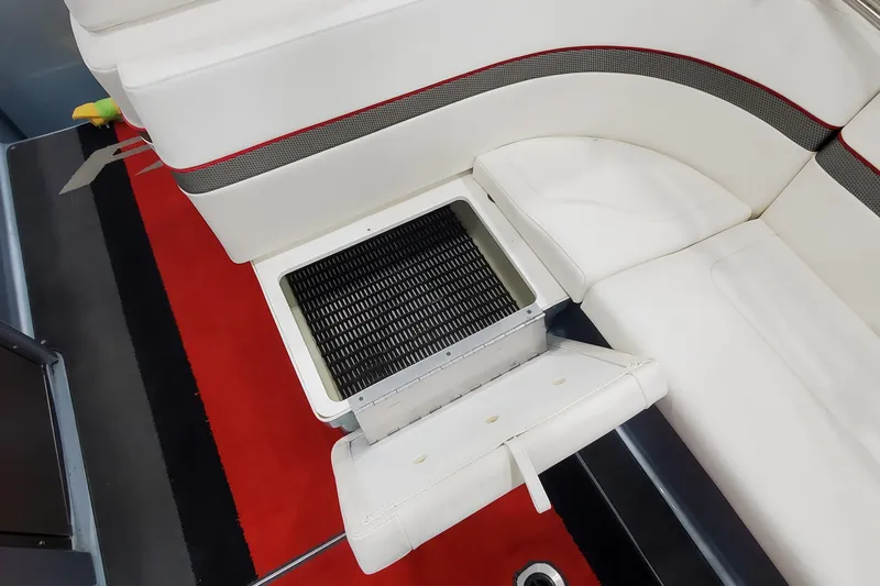 Slide: The Image of 2011 Formula 310 FX5 Bowrider interior seating with storage compartment and stainless steel railings. - 11