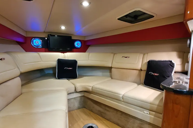 Slide: The Image of 2011 Formula 310 FX5 Bowrider interior storage compartment with beige seating and wooden flooring. - 34