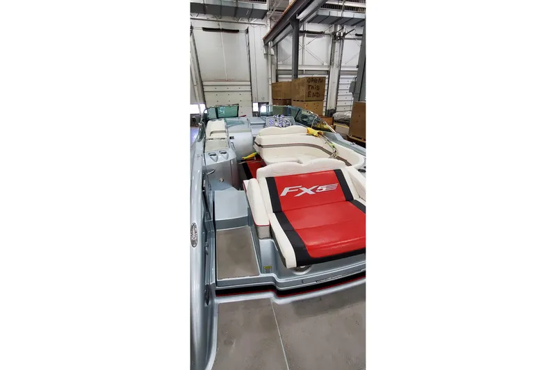 Slide: The Image of 2011 Formula 310 FX5 Bowrider with open storage compartments and visible accessories. - 5