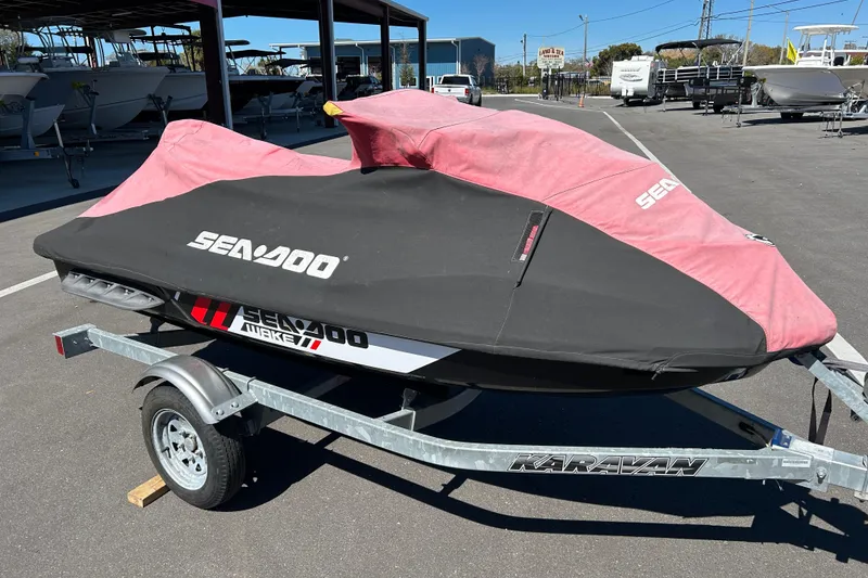 Slide: The Image of 2012 Sea-Doo Wake 155 jet ski covered on a trailer in a parking lot. - 12