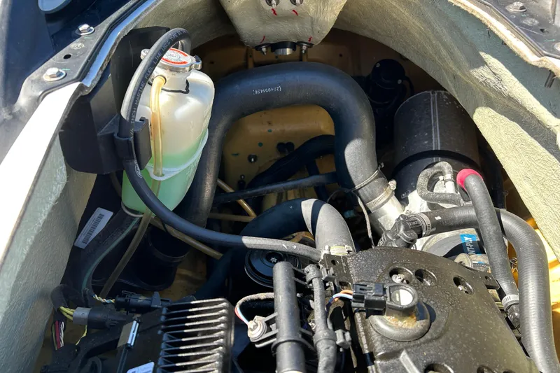 Slide: The Image of Engine compartment of a 2012 Sea-Doo Wake 155, showing hoses and components. - 8