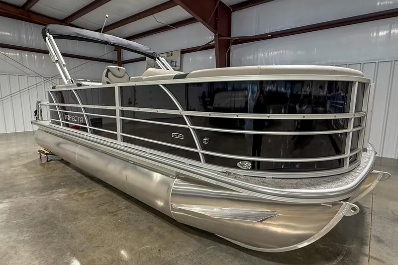 Slide: The Image of 2025 Trifecta 22RF LE pontoon boat in a showroom, featuring sleek design and modern amenities. - 3