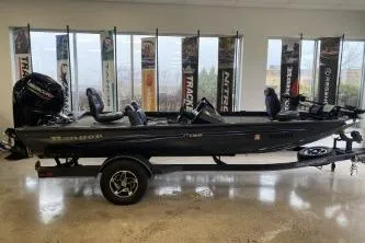 Slide: The Image of 2023 Ranger RT188 fishing boat in showroom, side view with banners in background. - 2