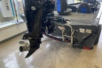 Slide: The Image of 2023 Ranger RT188 boat with outboard motor and ladder in showroom. - 8