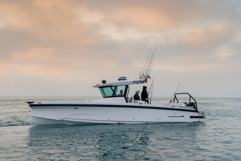 The Image of 2026 Axopar 29 CCX boat on calm water at sunset. - 0