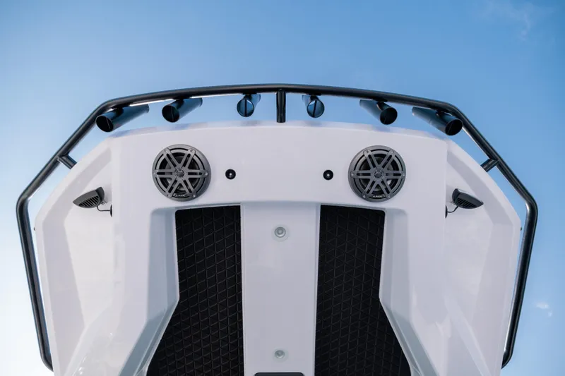 Slide: The Image of 2026 Axopar 29 CCX boat bow with speakers and railings against blue sky. - 10