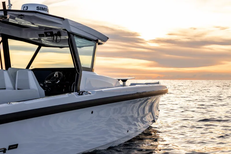 Slide: The Image of 2026 Axopar 29 CCX boat on calm sea at sunset. - 11