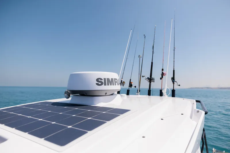 Slide: The Image of 2026 Axopar 29 CCX boat with solar panel and fishing rods on deck. - 8