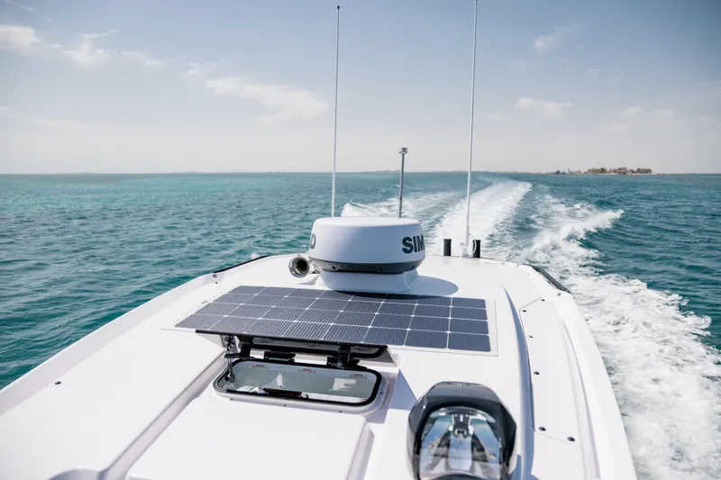 Slide: The Image of 2026 Axopar 29 CCX boat cruising on clear blue ocean waters. - 9