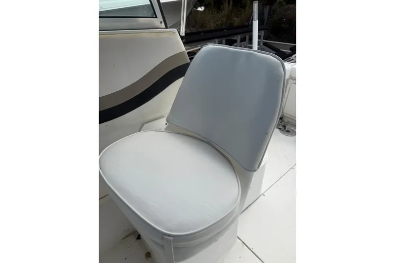 Slide: The Image of White seat on 2002 Seaswirl 2101 boat, featuring sleek design and comfortable cushioning. - 10