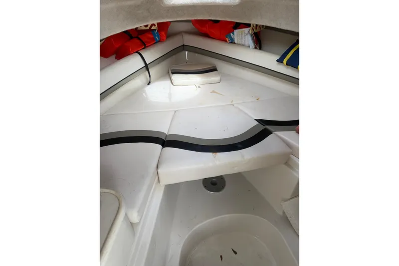 Slide: The Image of Interior of a 2002 Seaswirl 2101 boat with cushioned seating and life jackets. - 13
