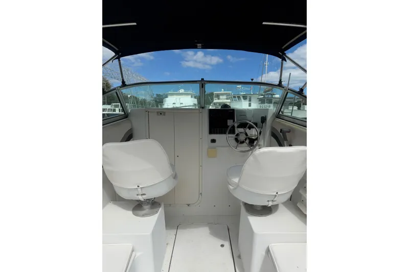 Slide: The Image of Interior view of 2002 Seaswirl 2101 boat cockpit with steering wheel and seats. - 6