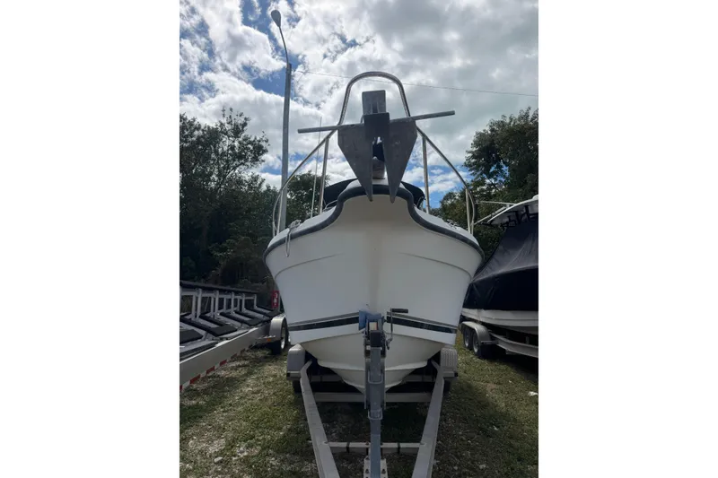 Slide: The Image of 2002 Seaswirl 2101 boat on trailer under cloudy sky. - 2