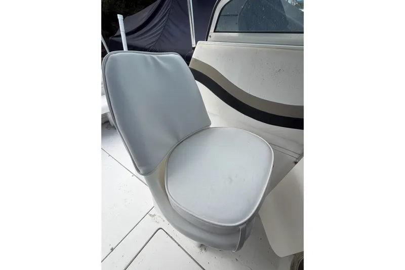 Slide: The Image of White cushioned seat on 2002 Seaswirl 2101 boat, featuring sleek design and comfort. - 9