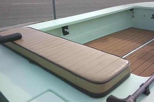 Slide: The Image of 2020 Skimmer Skiff 14 SKIFF boat interior with cushioned seating and wooden deck. - 13