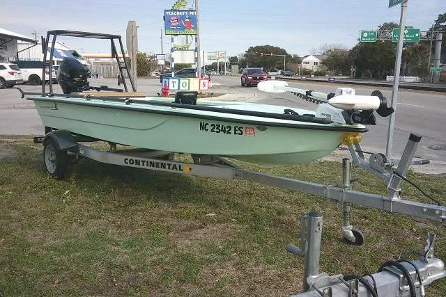 Slide: The Image of 2020 Skimmer Skiff 14 SKIFF on trailer, parked roadside with visible registration number. - 2