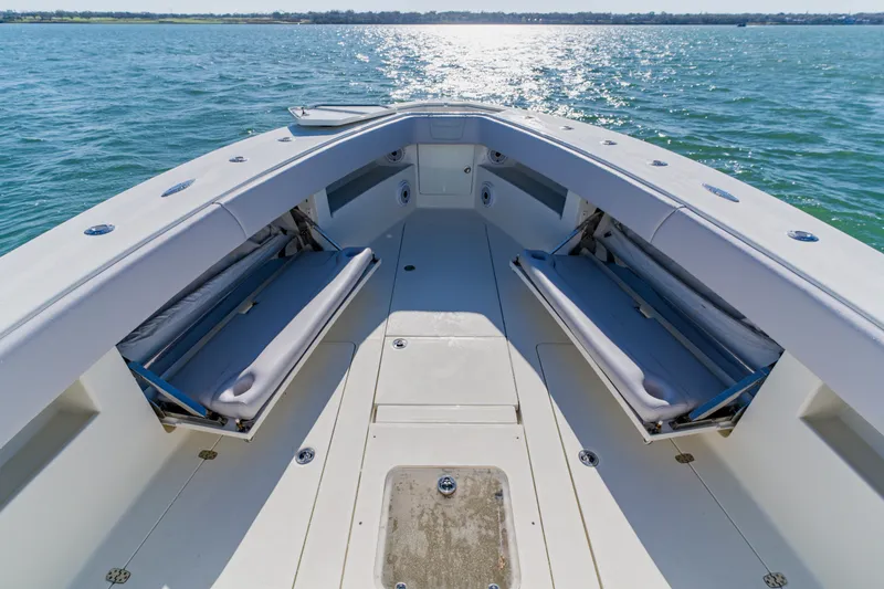Slide: The Image of 2012 SeaVee 390B boat interior with seating, on calm water. - 10