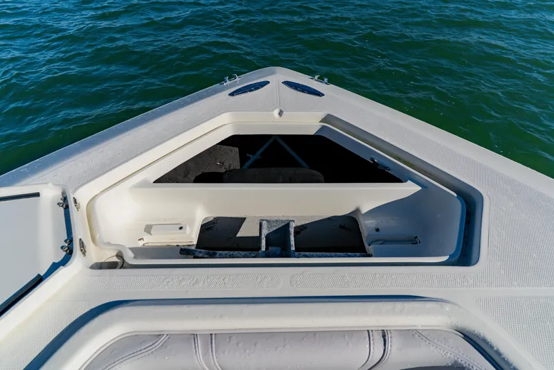 Slide: The Image of 2012 SeaVee 390B boat bow with open storage compartment on calm water. - 11