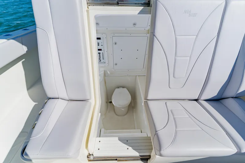 Slide: The Image of 2012 SeaVee 390B boat interior with hidden marine toilet under cushioned seating. - 15