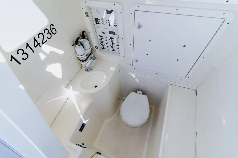 Slide: The Image of 2012 SeaVee 390B boat interior with toilet, sink, and control panel. - 16