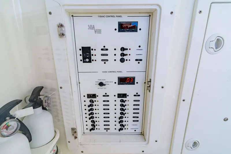 Slide: The Image of Electrical control panel on a 2012 SeaVee 390B boat, featuring switches and gauges. - 17