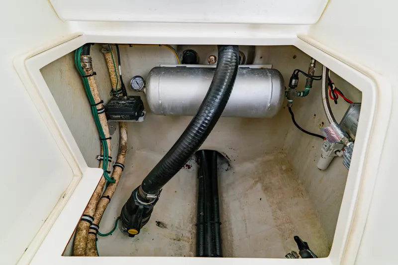 Slide: The Image of Bilge area of a 2012 SeaVee 390B boat with hoses and equipment. - 18