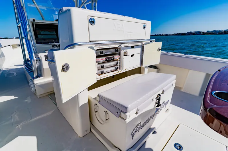 Slide: The Image of 2012 SeaVee 390B boat with open storage compartments and cooler on deck. - 32