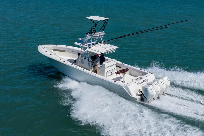 Slide: The Image of 2012 SeaVee 390B boat cruising on open water with triple outboard engines. - 4
