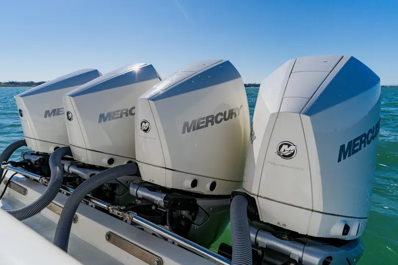 Slide: The Image of Triple Mercury outboard engines on a 2012 SeaVee 390B boat in open water. - 40