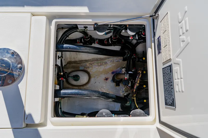 Slide: The Image of 2012 SeaVee 390B boat compartment with visible wiring and hoses. - 41
