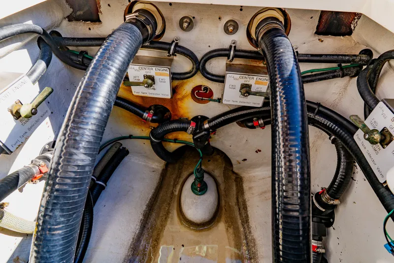 Slide: The Image of Engine compartment of 2012 SeaVee 390B boat showing fuel tank selector valves and hoses. - 44